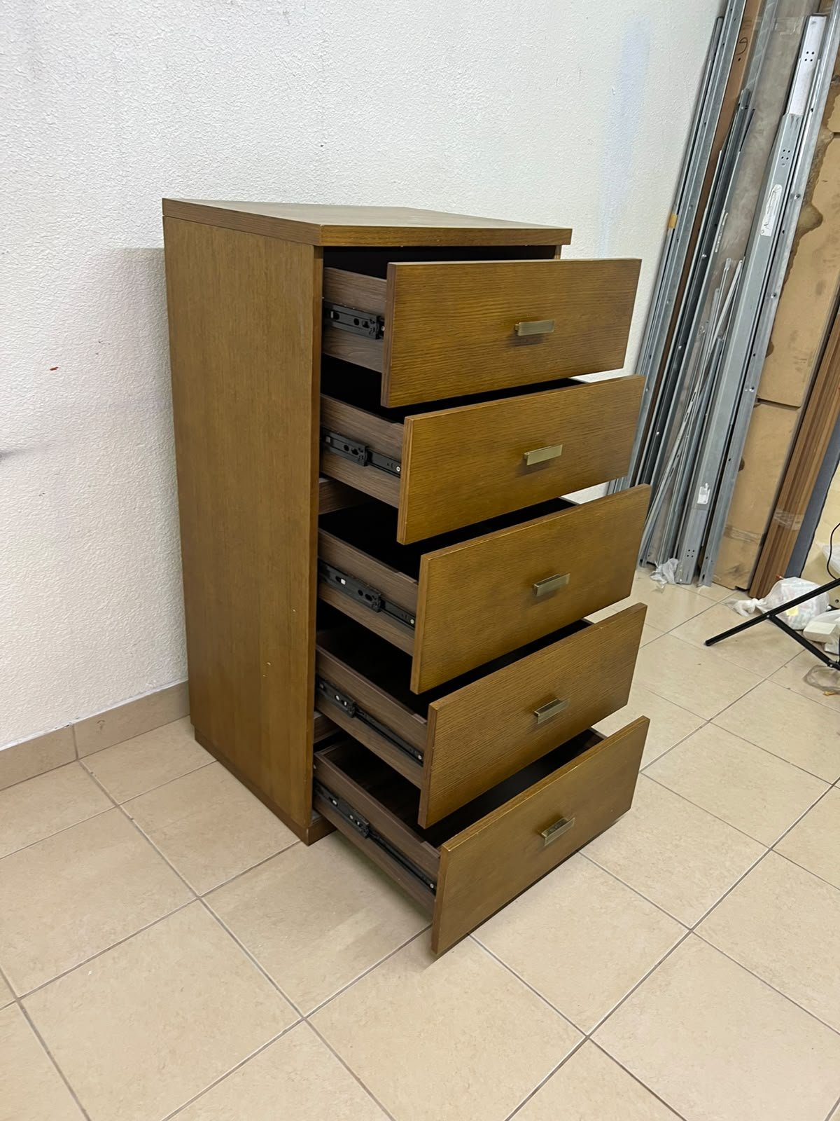 A tall, classic-style wooden chest of drawers, featuring elegant gold metal handles neatly arranged on each drawer. - Image 8