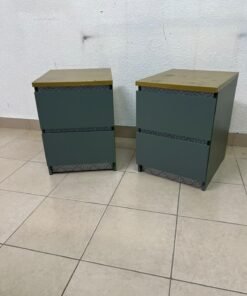 A bedside table featuring a minimalist design, grey-green drawers, and a wooden or yellowish top surface; the style resembles modern storage furniture. - Image 2
