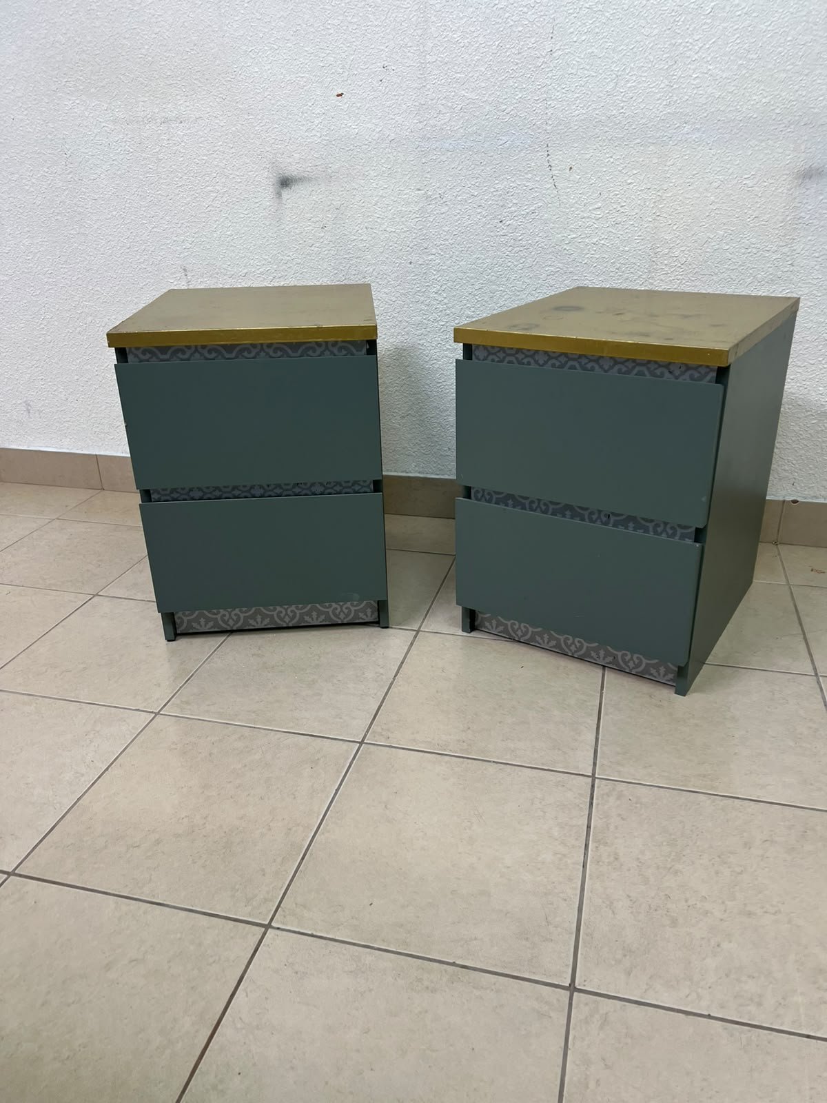 A bedside table featuring a minimalist design, grey-green drawers, and a wooden or yellowish top surface; the style resembles modern storage furniture. - Image 2