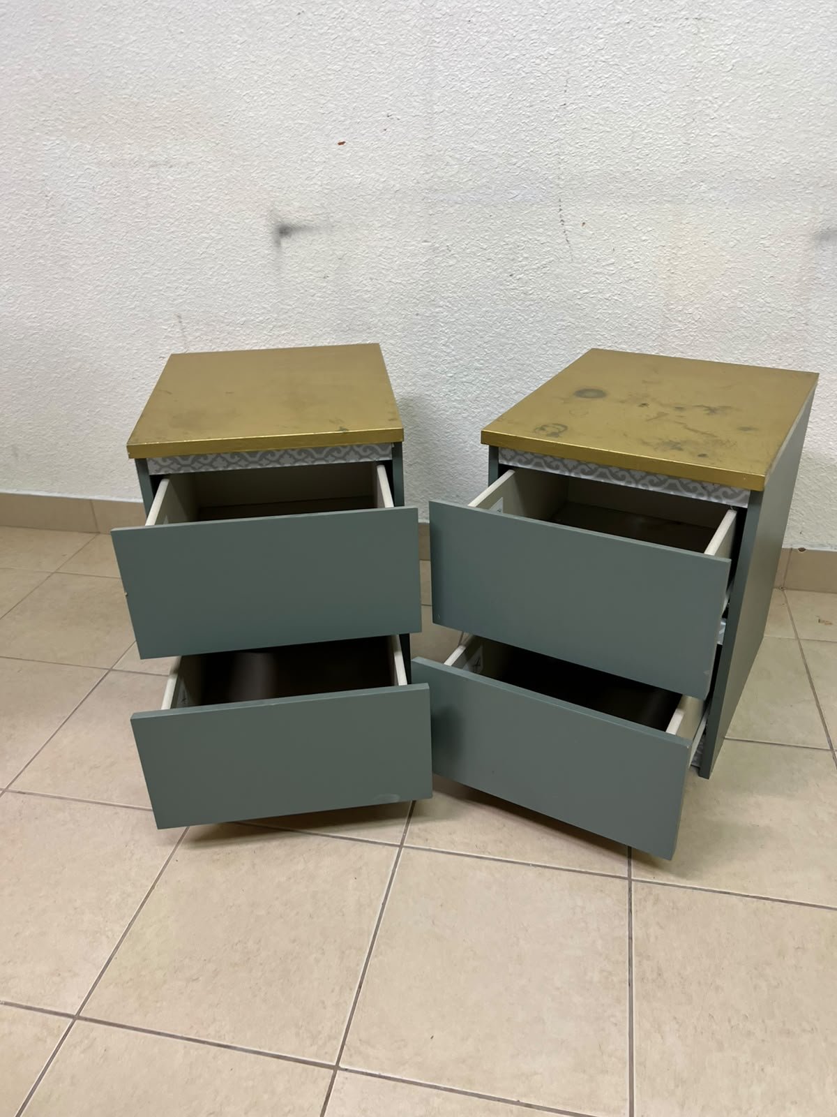 A bedside table featuring a minimalist design, grey-green drawers, and a wooden or yellowish top surface; the style resembles modern storage furniture. - Image 3