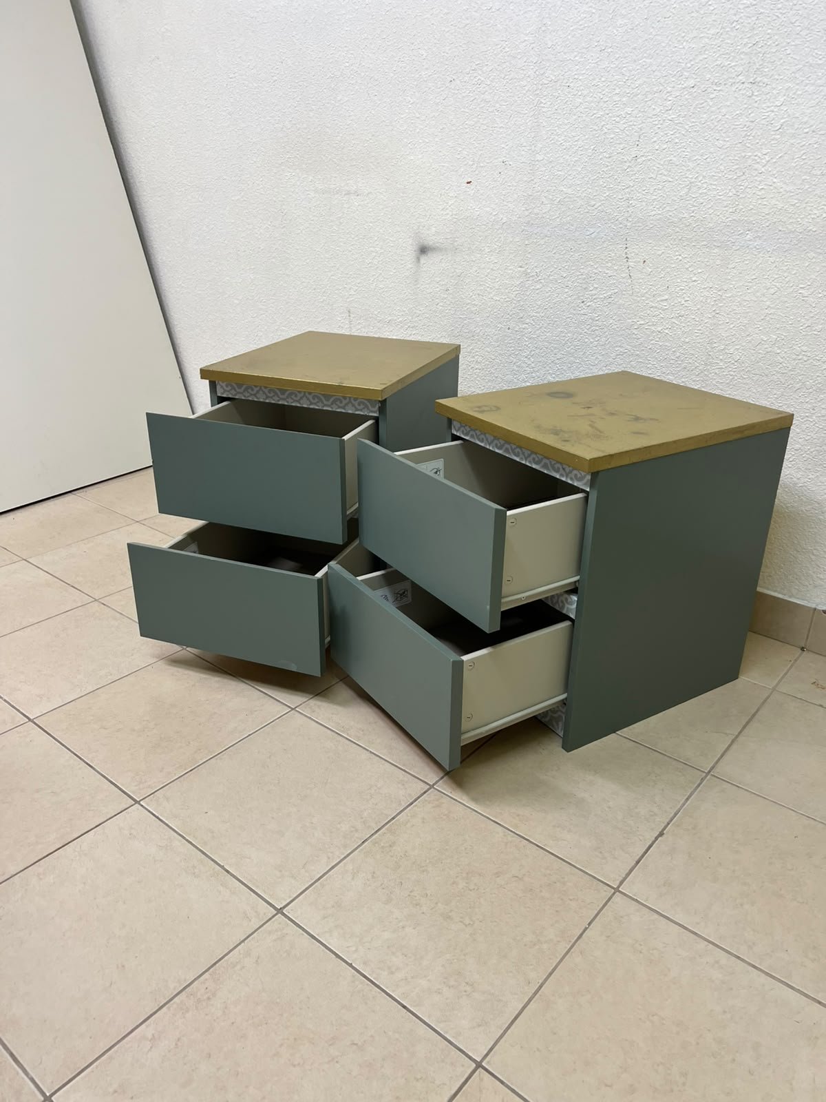 A bedside table featuring a minimalist design, grey-green drawers, and a wooden or yellowish top surface; the style resembles modern storage furniture. - Image 4