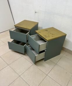 A bedside table featuring a minimalist design, grey-green drawers, and a wooden or yellowish top surface; the style resembles modern storage furniture. - Image 10