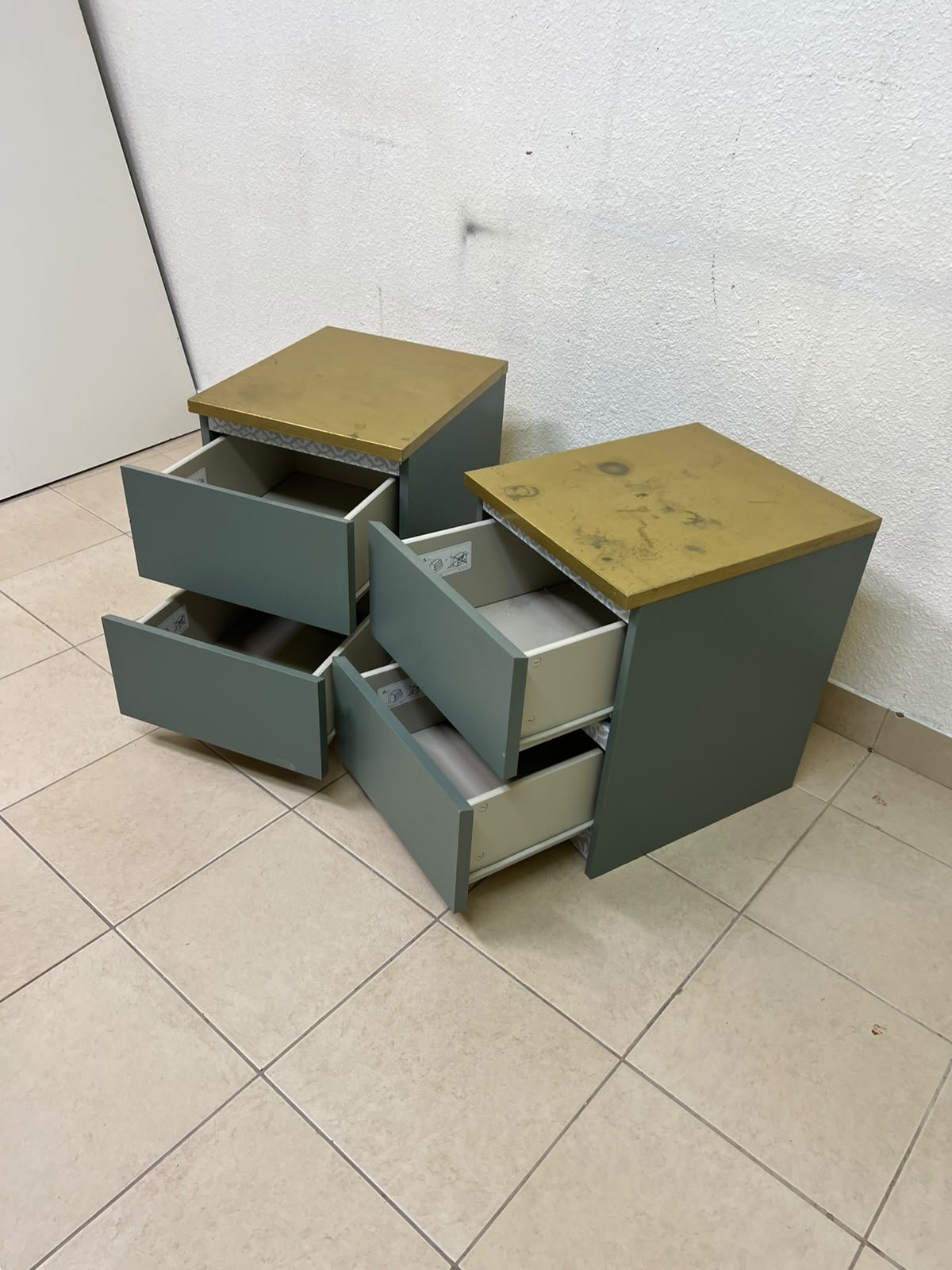A bedside table featuring a minimalist design, grey-green drawers, and a wooden or yellowish top surface; the style resembles modern storage furniture. - Image 10