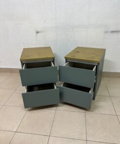 A bedside table featuring a minimalist design, grey-green drawers, and a wooden or yellowish top surface; the style resembles modern storage furniture. - Image 9