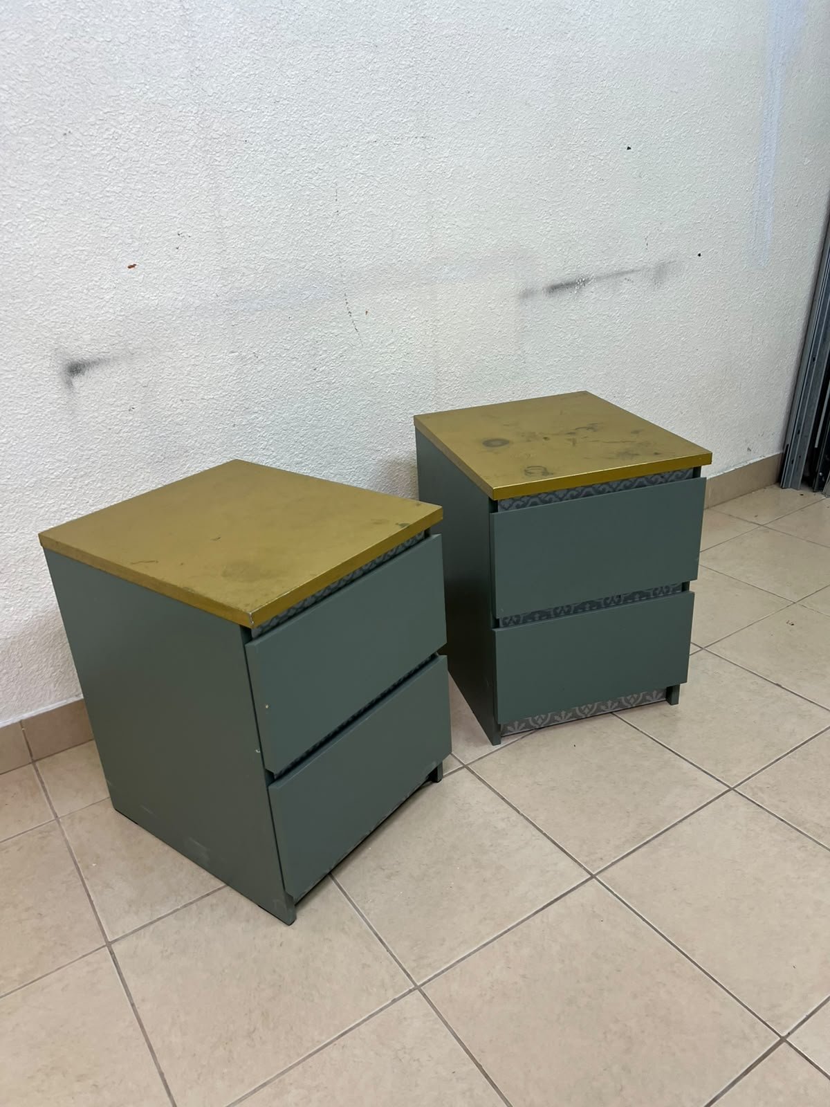 A bedside table featuring a minimalist design, grey-green drawers, and a wooden or yellowish top surface; the style resembles modern storage furniture. - Image 7