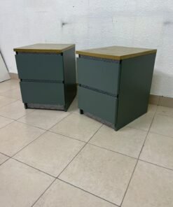A bedside table featuring a minimalist design, grey-green drawers, and a wooden or yellowish top surface; the style resembles modern storage furniture. - Image 6