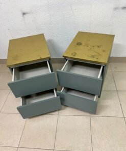 A bedside table featuring a minimalist design, grey-green drawers, and a wooden or yellowish top surface; the style resembles modern storage furniture. - Image 5