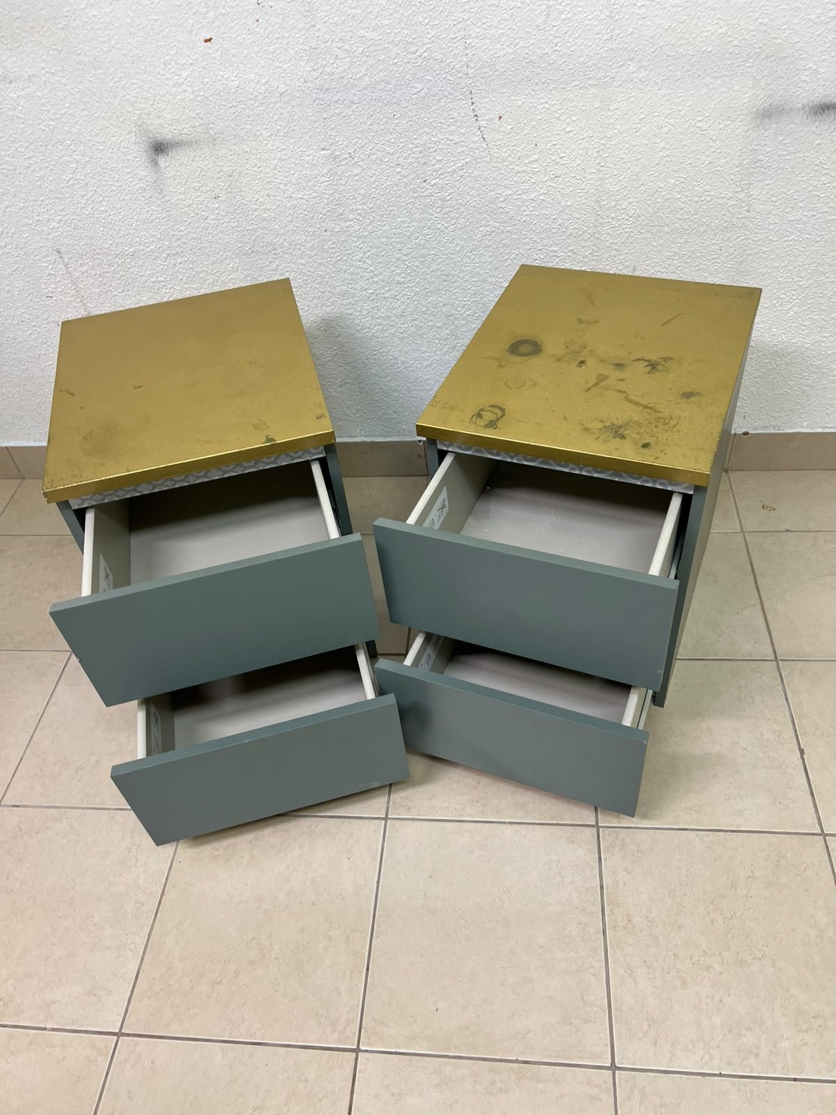 A bedside table featuring a minimalist design, grey-green drawers, and a wooden or yellowish top surface; the style resembles modern storage furniture. - Image 5