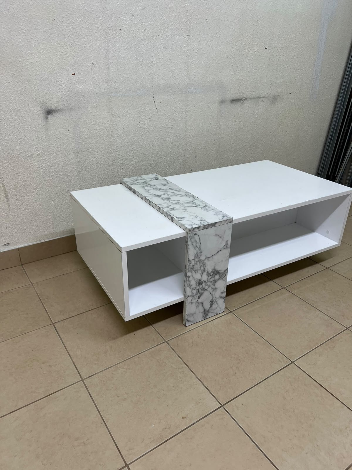 A modern living room coffee table combining white with a faux-marble finish. - Image 9