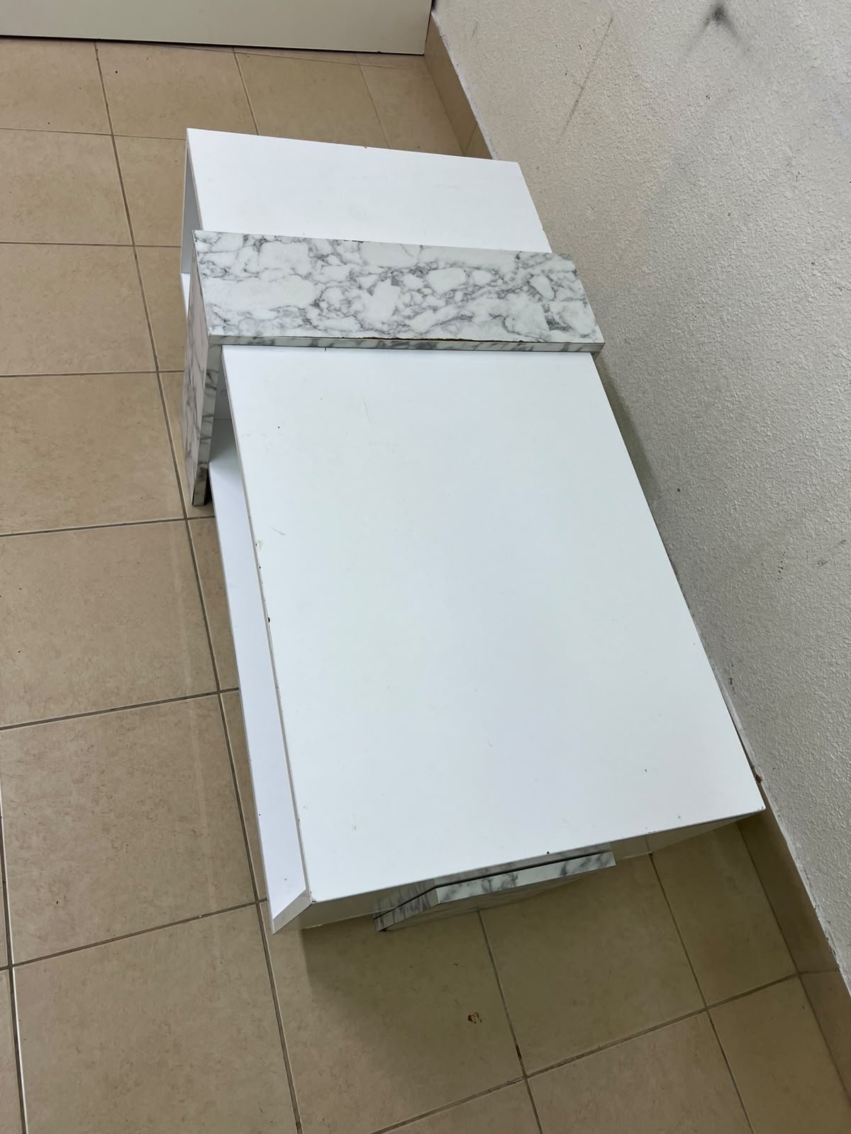 A modern living room coffee table combining white with a faux-marble finish. - Image 7