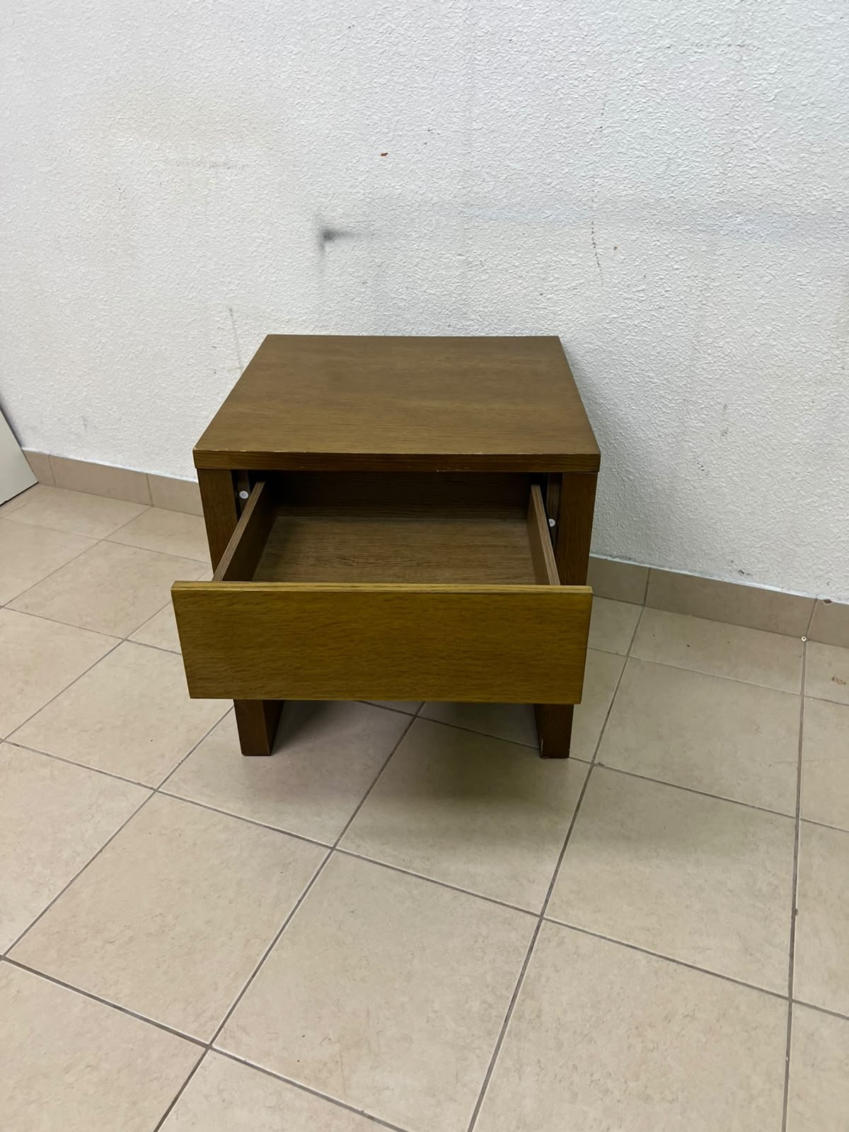 This wooden table—featuring a distinctive finish and a single drawer—is a piece of Czech furniture that complements contemporary bedroom décor. - Image 8