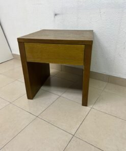 This wooden table—featuring a distinctive finish and a single drawer—is a piece of Czech furniture that complements contemporary bedroom décor. - Image 2