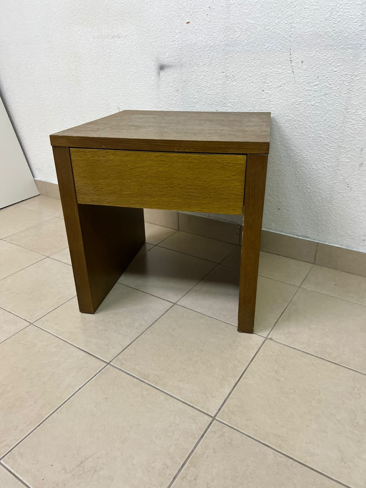 This wooden table—featuring a distinctive finish and a single drawer—is a piece of Czech furniture that complements contemporary bedroom décor. - Image 2