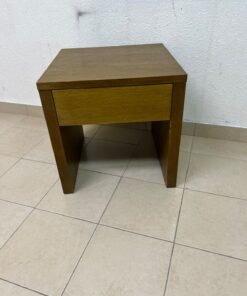 This wooden table—featuring a distinctive finish and a single drawer—is a piece of Czech furniture that complements contemporary bedroom décor. - Image 5