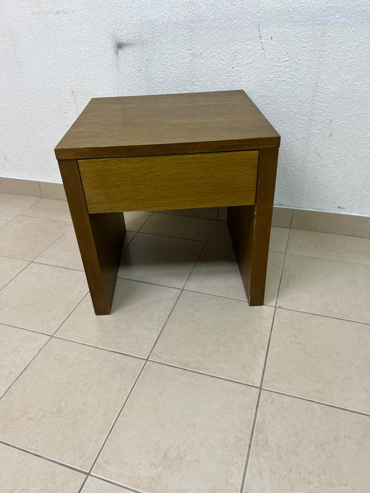 This wooden table—featuring a distinctive finish and a single drawer—is a piece of Czech furniture that complements contemporary bedroom décor. - Image 5