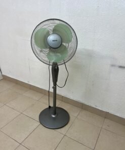 A Sanyo-branded grey pedestal fan featuring light green blades and a circular base. - Image 2