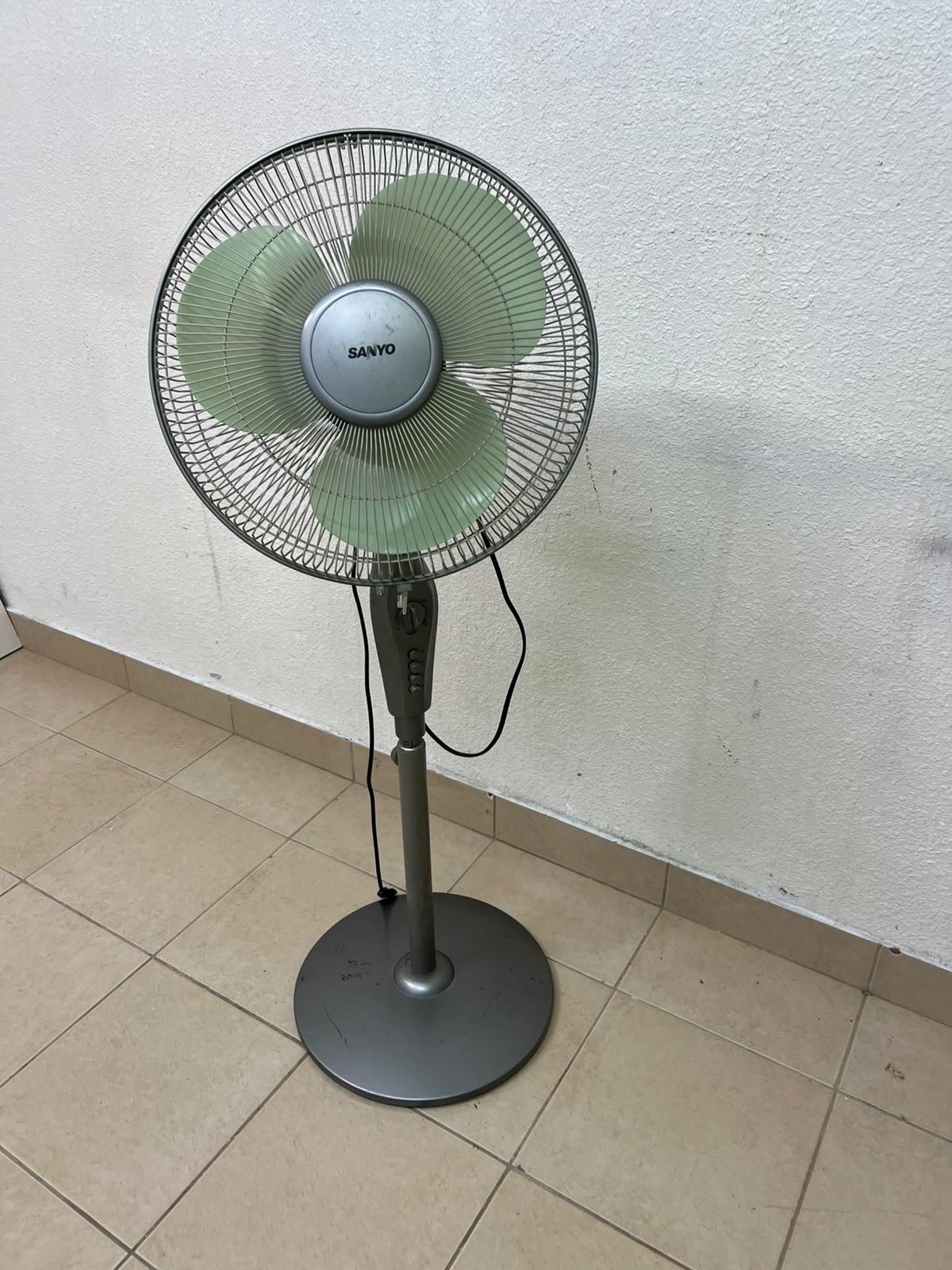 A Sanyo-branded grey pedestal fan featuring light green blades and a circular base. - Image 4