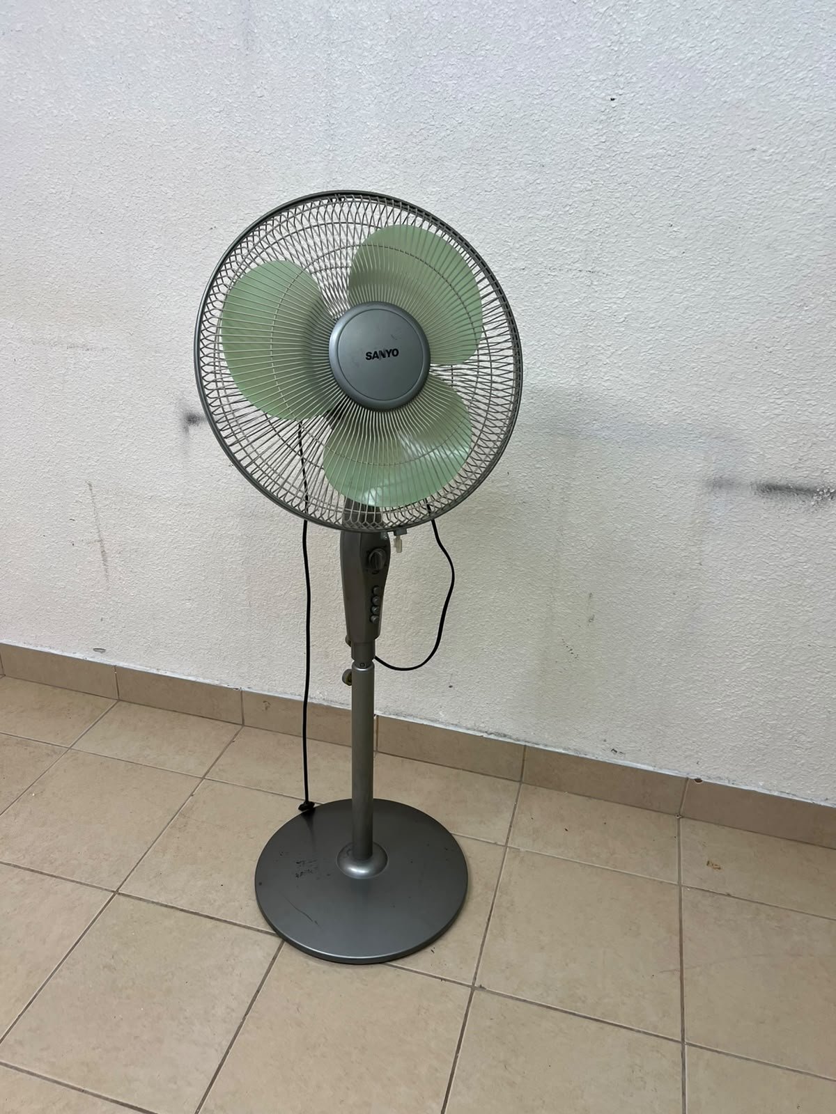 A Sanyo-branded grey pedestal fan featuring light green blades and a circular base. - Image 5