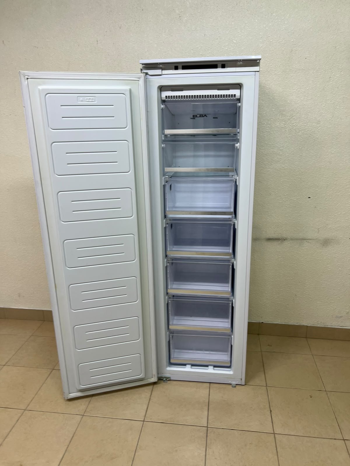 A white built-in upright freezer featuring multiple transparent storage drawers.