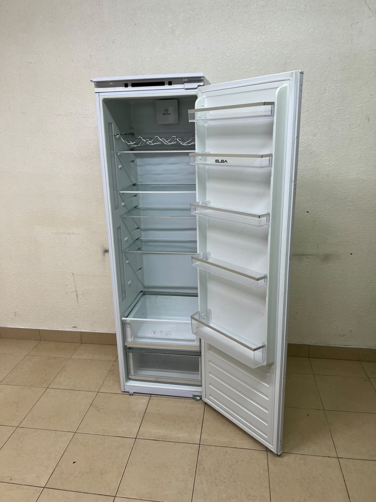 An Elba built-in single-door refrigerator featuring a white design, adjustable glass shelves, and a metal bottle rack. - Image 2