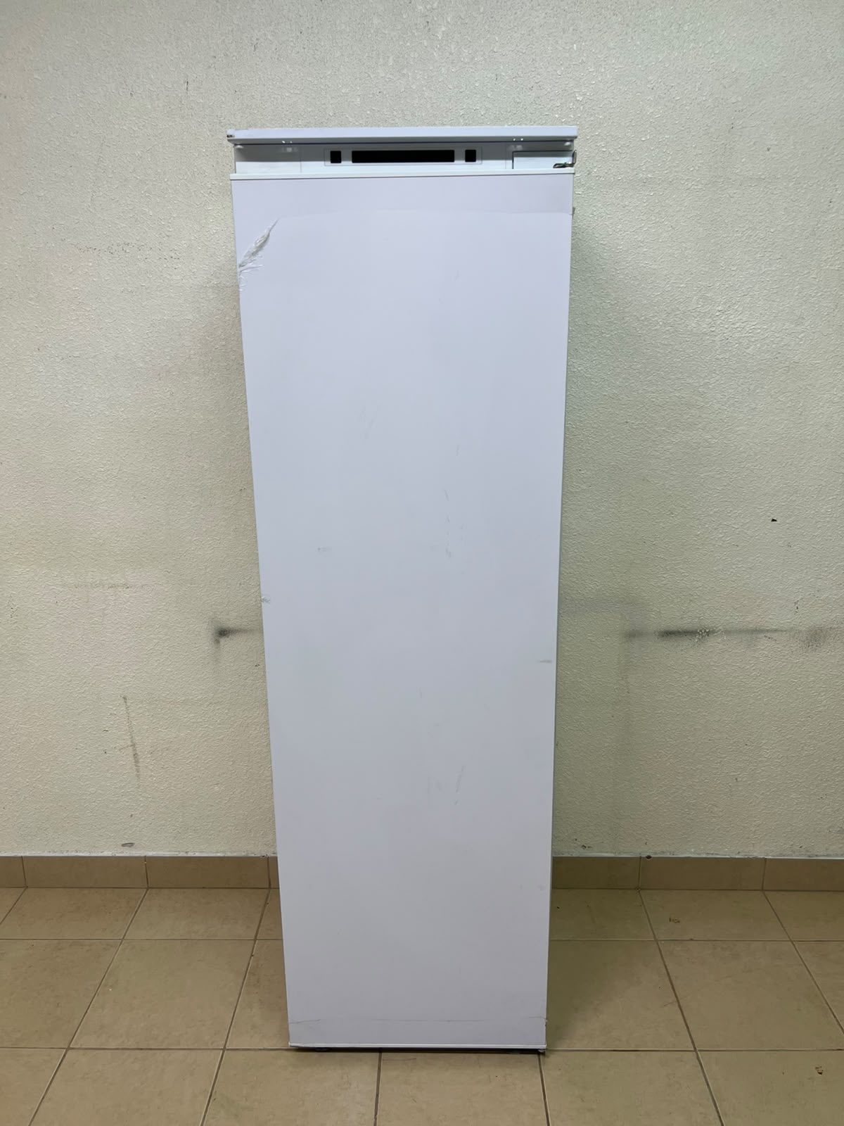 An Elba built-in single-door refrigerator featuring a white design, adjustable glass shelves, and a metal bottle rack. - Image 3