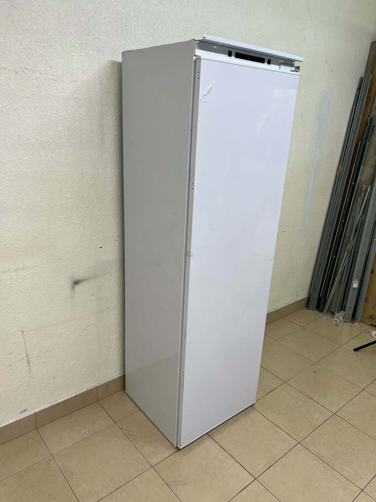 An Elba built-in single-door refrigerator featuring a white design, adjustable glass shelves, and a metal bottle rack. - Image 4