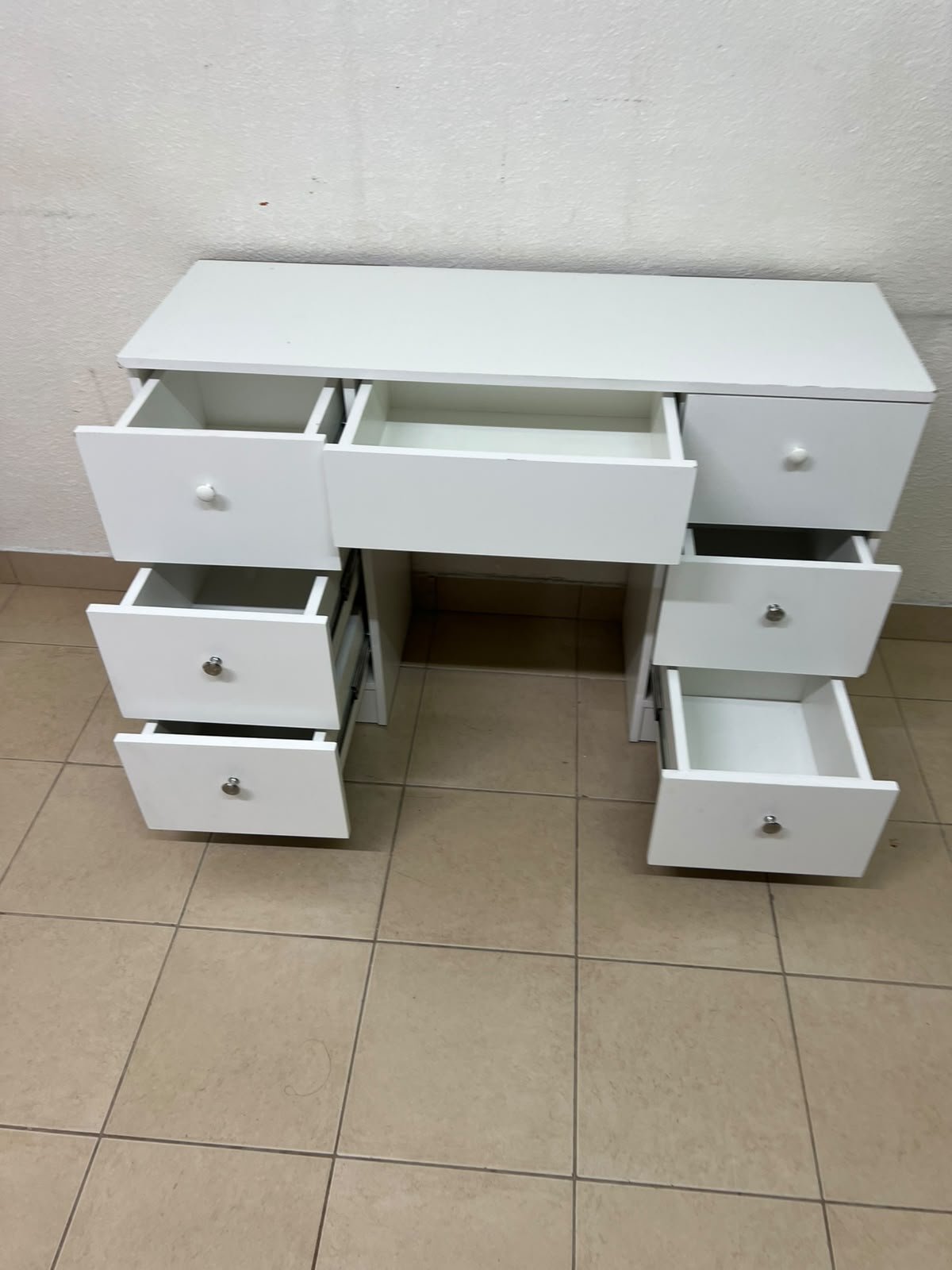 A white vanity desk featuring a modern, practical design, complete with seven storage drawers and elegant round handles. - Image 3