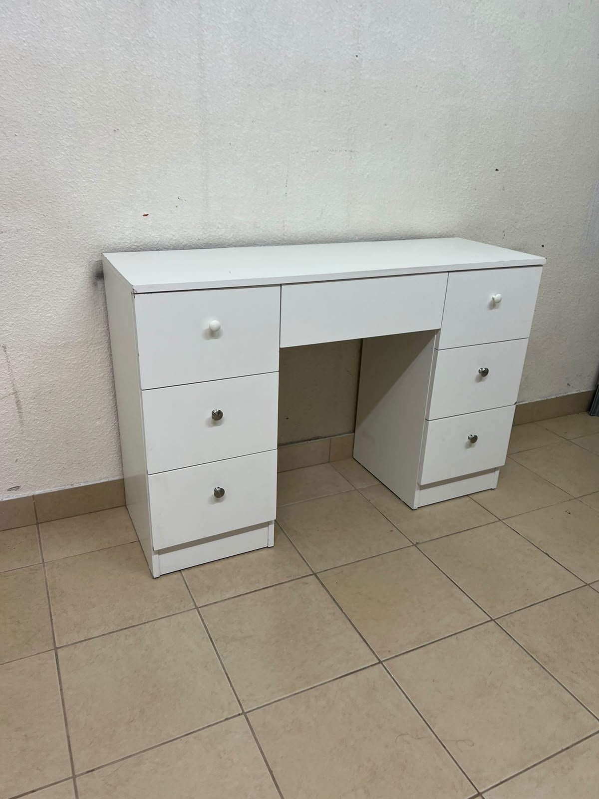 A white vanity desk featuring a modern, practical design, complete with seven storage drawers and elegant round handles. - Image 2