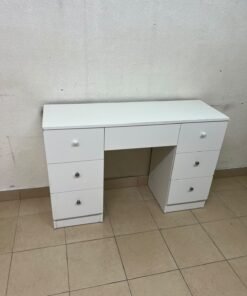 A white vanity desk featuring a modern, practical design, complete with seven storage drawers and elegant round handles.