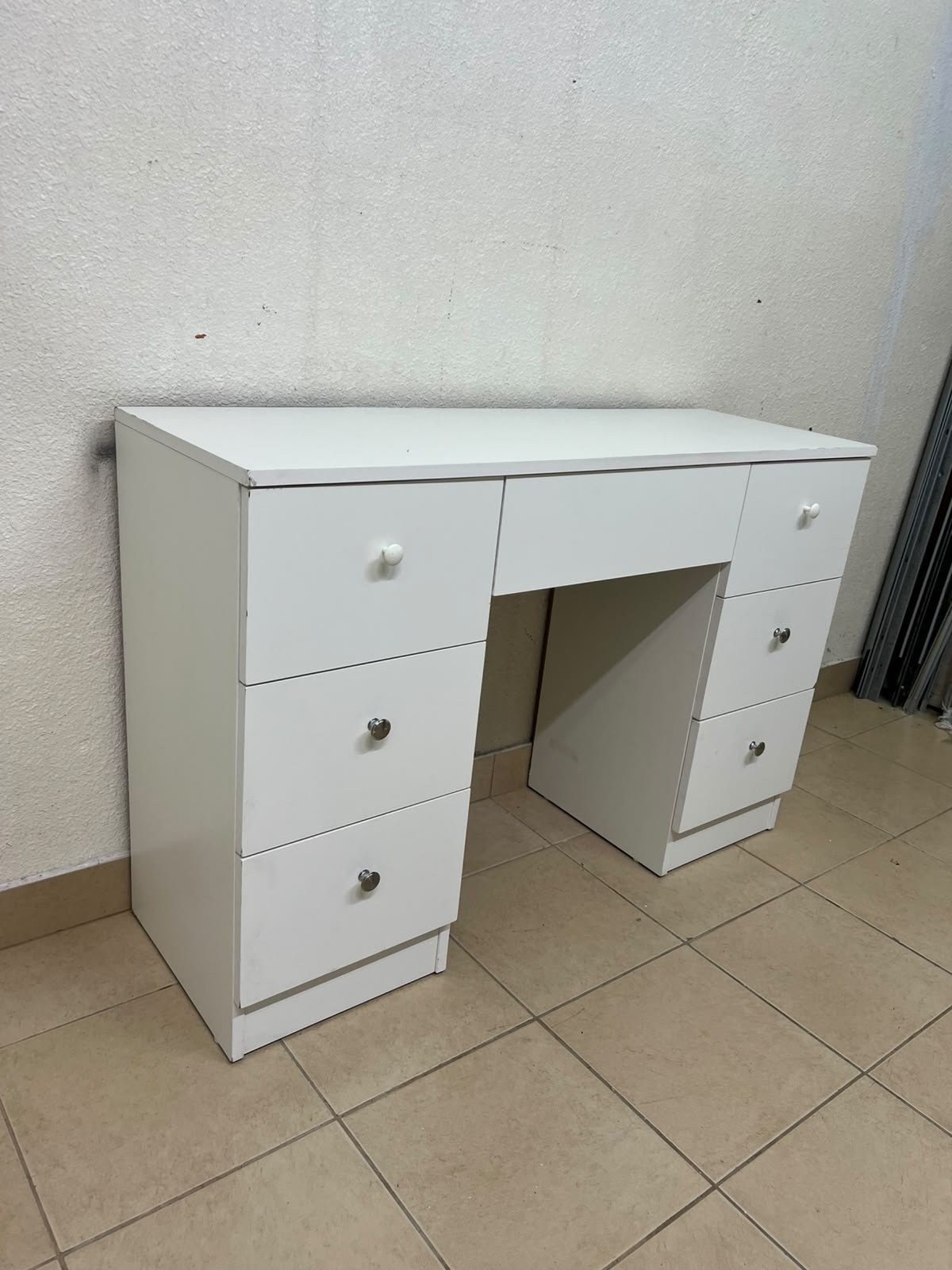 A white vanity desk featuring a modern, practical design, complete with seven storage drawers and elegant round handles. - Image 5