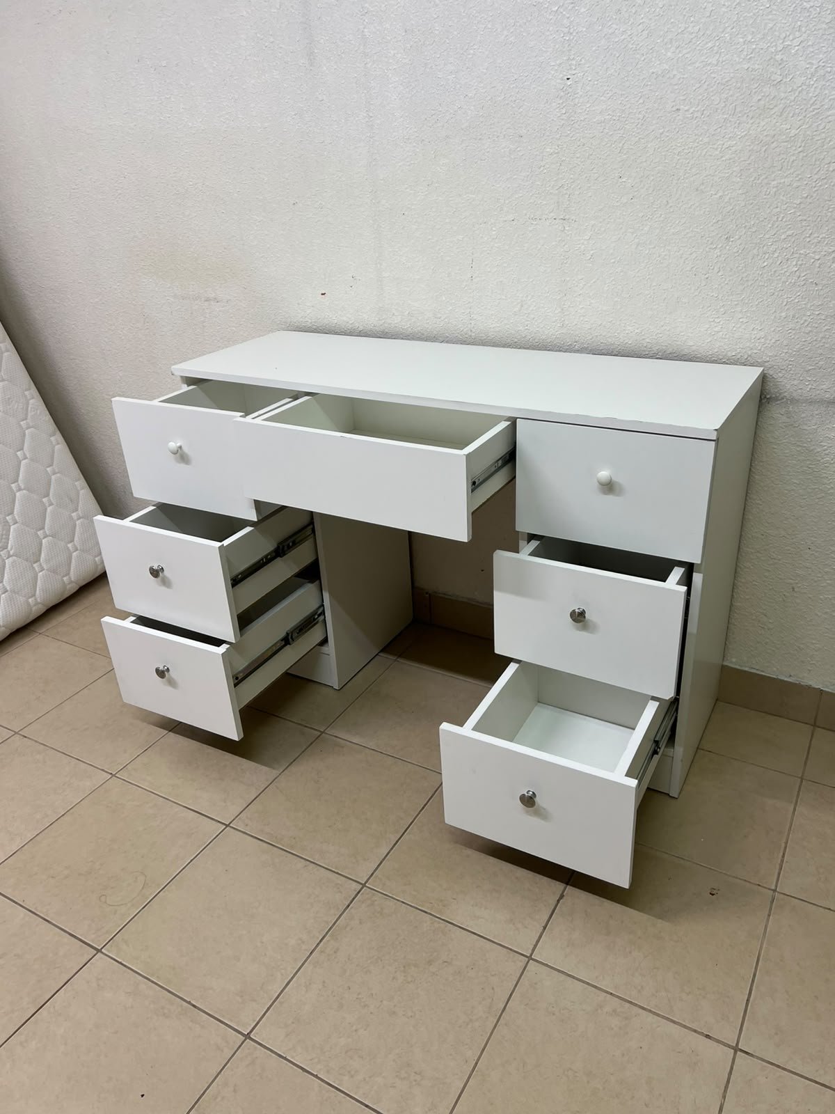 A white vanity desk featuring a modern, practical design, complete with seven storage drawers and elegant round handles. - Image 6