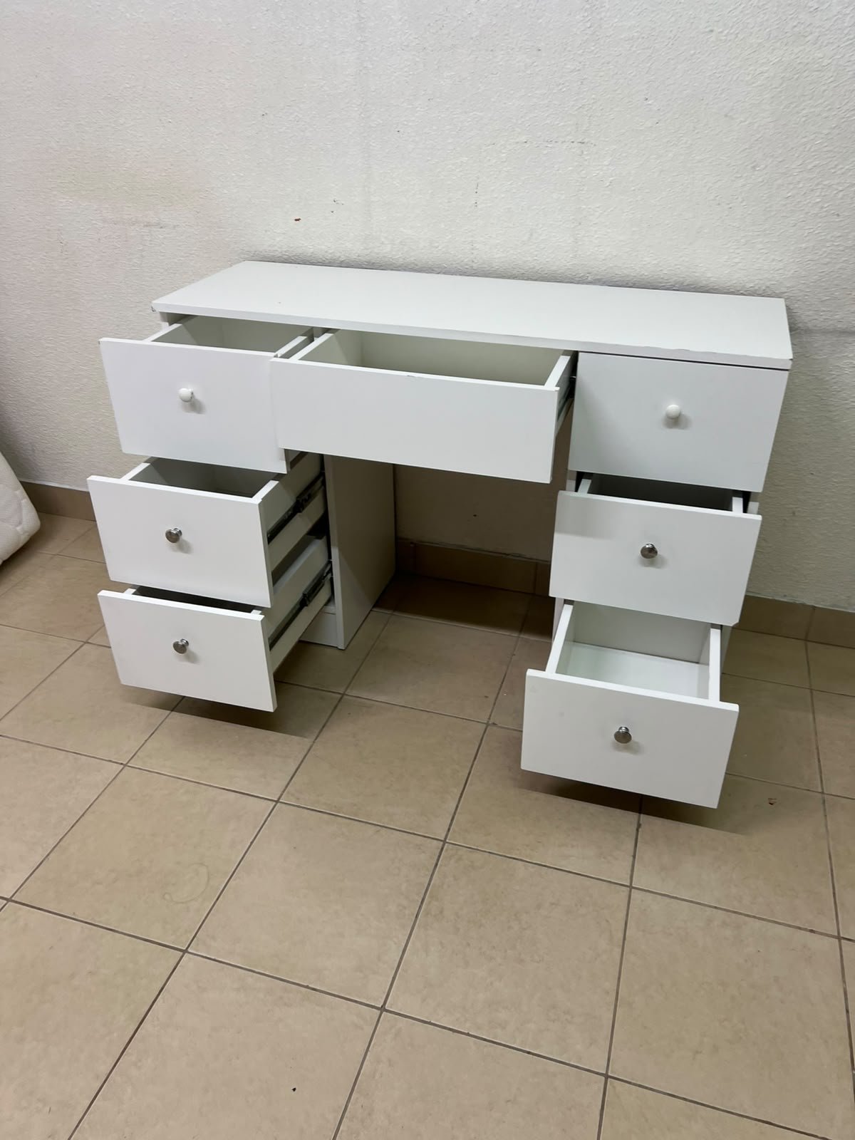 A white vanity desk featuring a modern, practical design, complete with seven storage drawers and elegant round handles. - Image 8
