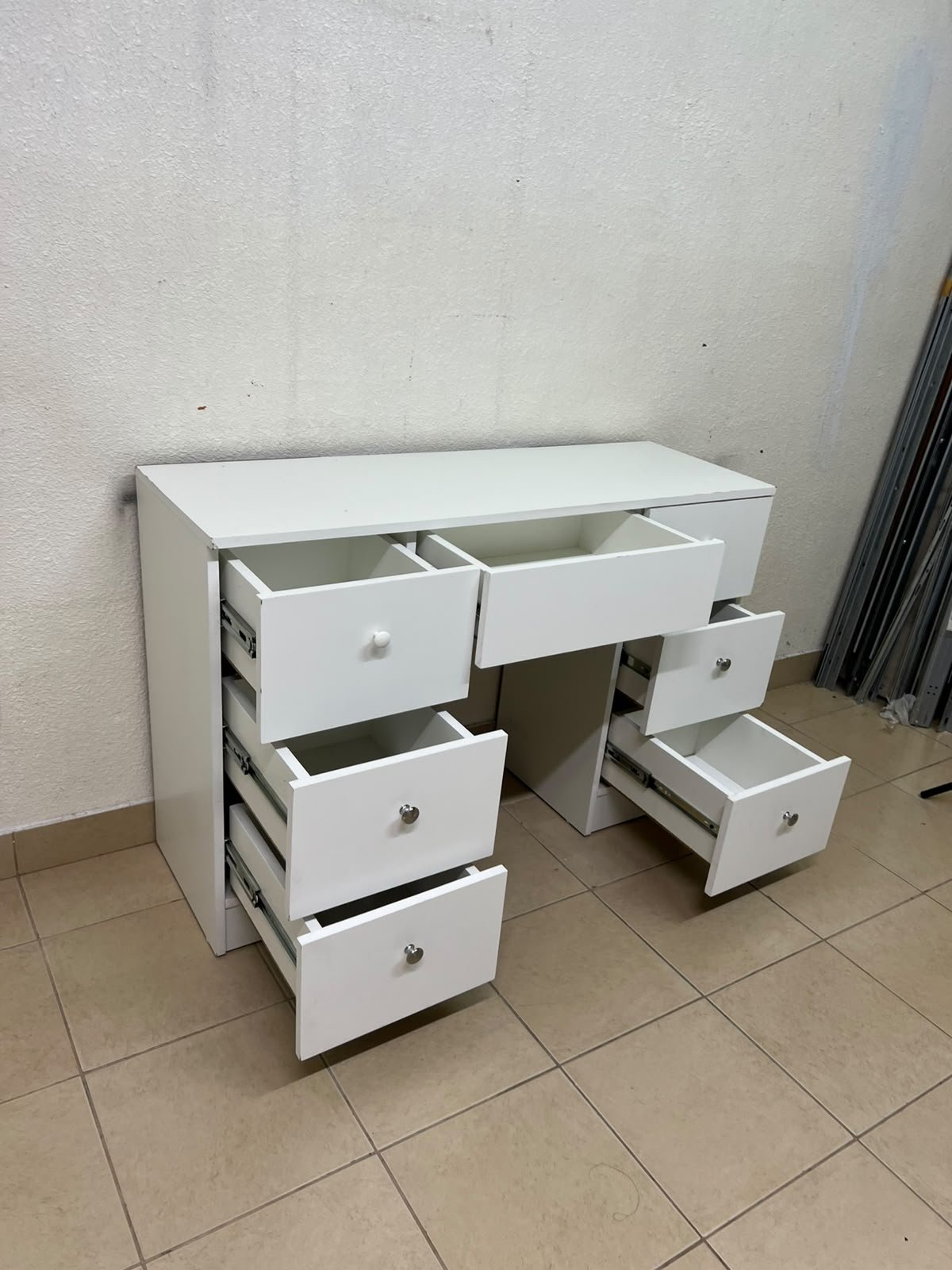 A white vanity desk featuring a modern, practical design, complete with seven storage drawers and elegant round handles. - Image 9