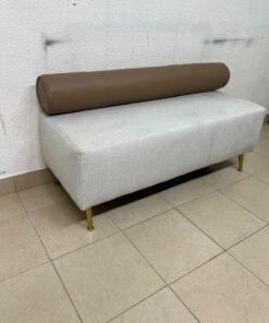 The light-gray upholstered seat, featuring a brown cylindrical backrest and gold legs, is a stylish, modern piece of furniture that adds a distinctive touch to the décor. - Image 2