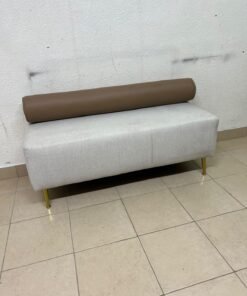 The light-gray upholstered seat, featuring a brown cylindrical backrest and gold legs, is a stylish, modern piece of furniture that adds a distinctive touch to the décor. - Image 4