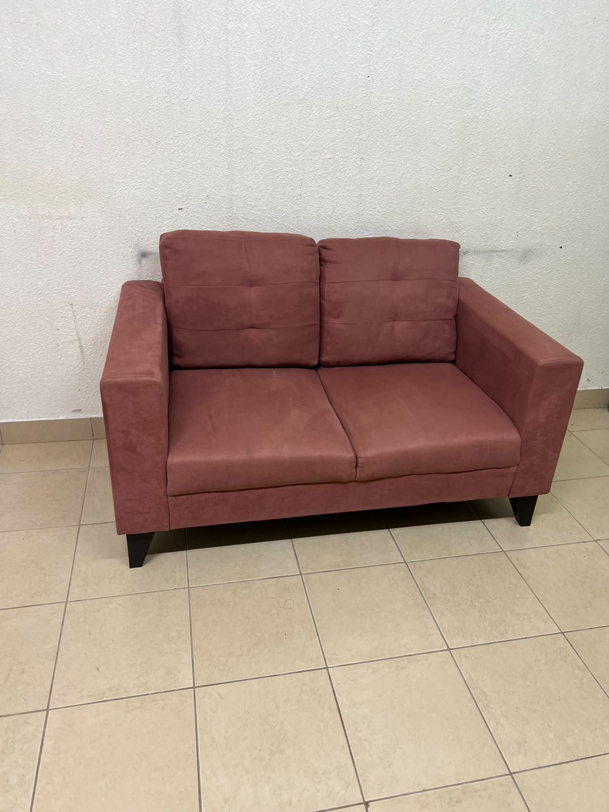 A red or dark pink two-seater fabric sofa featuring wide armrests and back cushions adorned with a checkered pattern. - Image 2