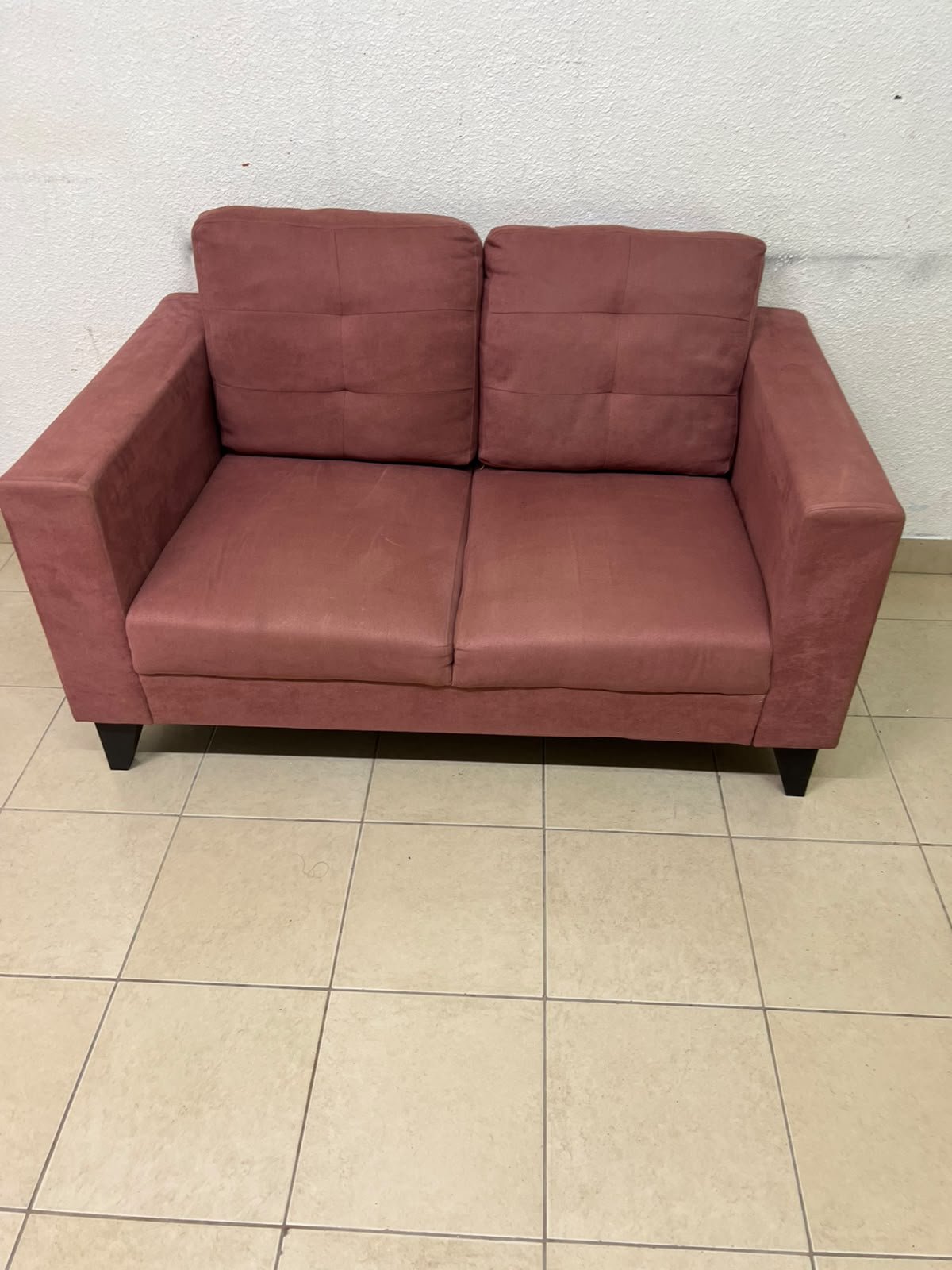A red or dark pink two-seater fabric sofa featuring wide armrests and back cushions adorned with a checkered pattern. - Image 6