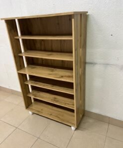 The wooden shoe cabinet, featuring open shelves and small white legs, is a practical and stylish piece for organizing the entryway. - Image 3
