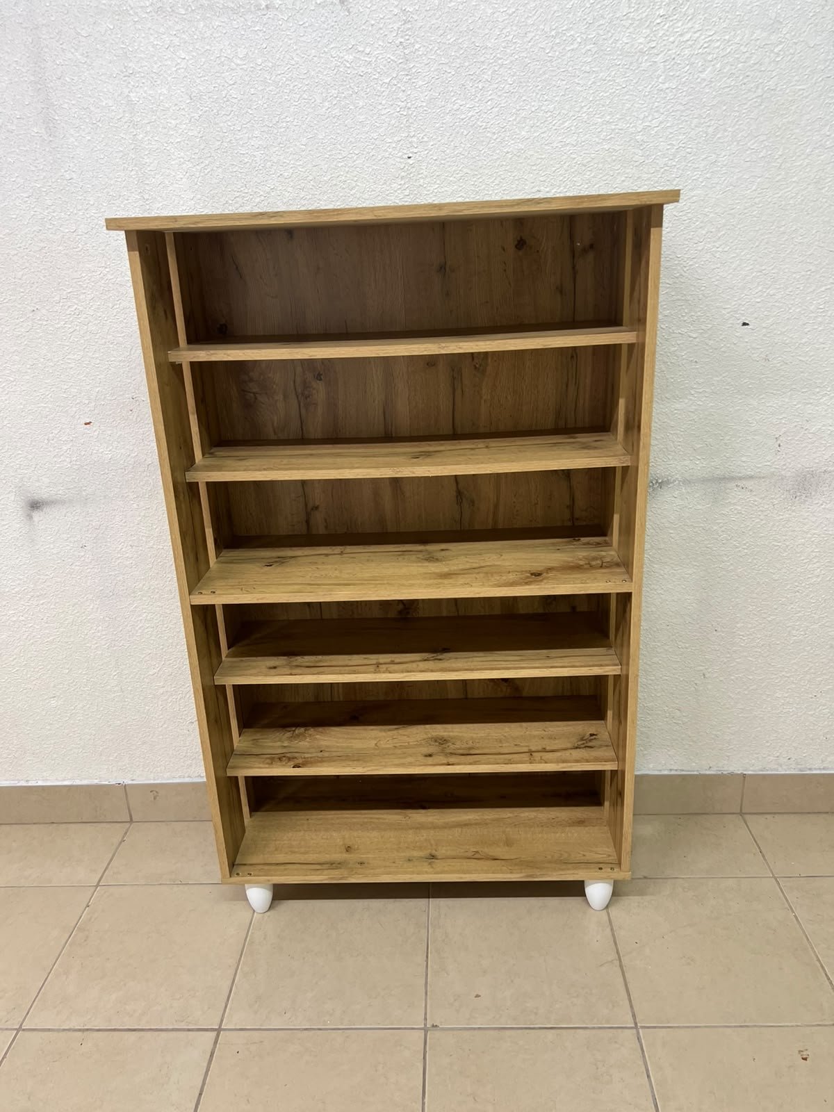 The wooden shoe cabinet, featuring open shelves and small white legs, is a practical and stylish piece for organizing the entryway. - Image 5