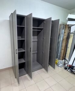 The image shows the Jamora four-door wardrobe from Danube Home, featuring a warm grey color and a practical design with hinged doors and simple black handles. - Image 4