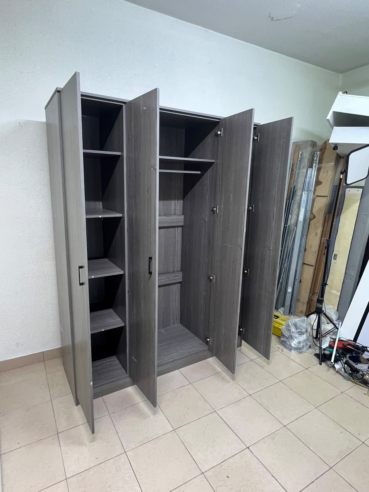 The image shows the Jamora four-door wardrobe from Danube Home, featuring a warm grey color and a practical design with hinged doors and simple black handles. - Image 4