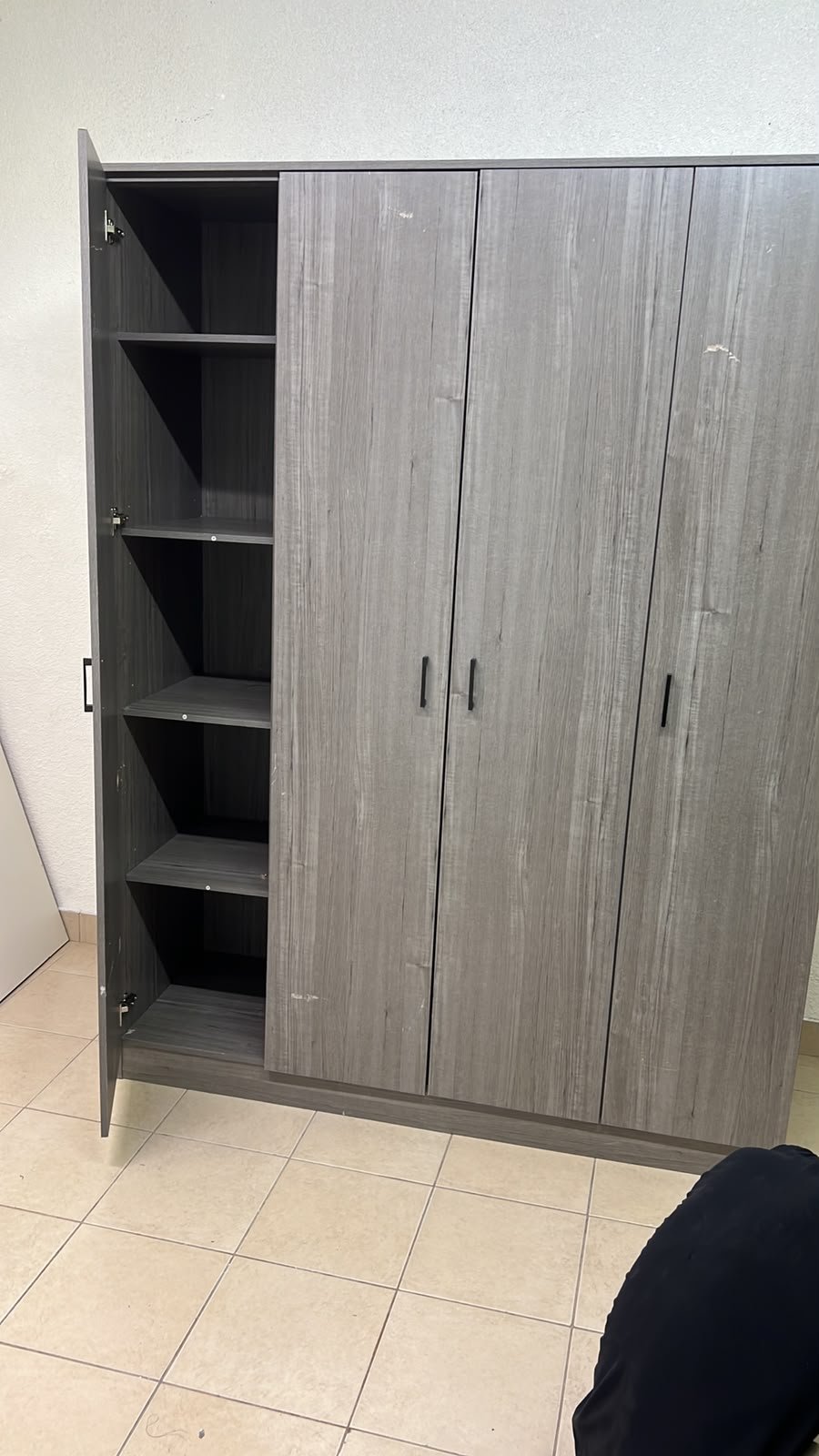 The image shows the Jamora four-door wardrobe from Danube Home, featuring a warm grey color and a practical design with hinged doors and simple black handles. - Image 6