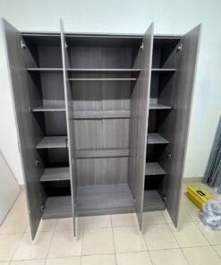 The image shows the Jamora four-door wardrobe from Danube Home, featuring a warm grey color and a practical design with hinged doors and simple black handles. - Image 11