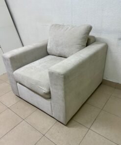 The single chair, upholstered in light gray fabric, resembles modern seating designs characterized by wide, comfortable armrests. - Image 3