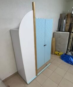 The photo shows a children's wardrobe with a distinctive nautical design in blue and white with wooden details and wave-like top edges. - Image 2
