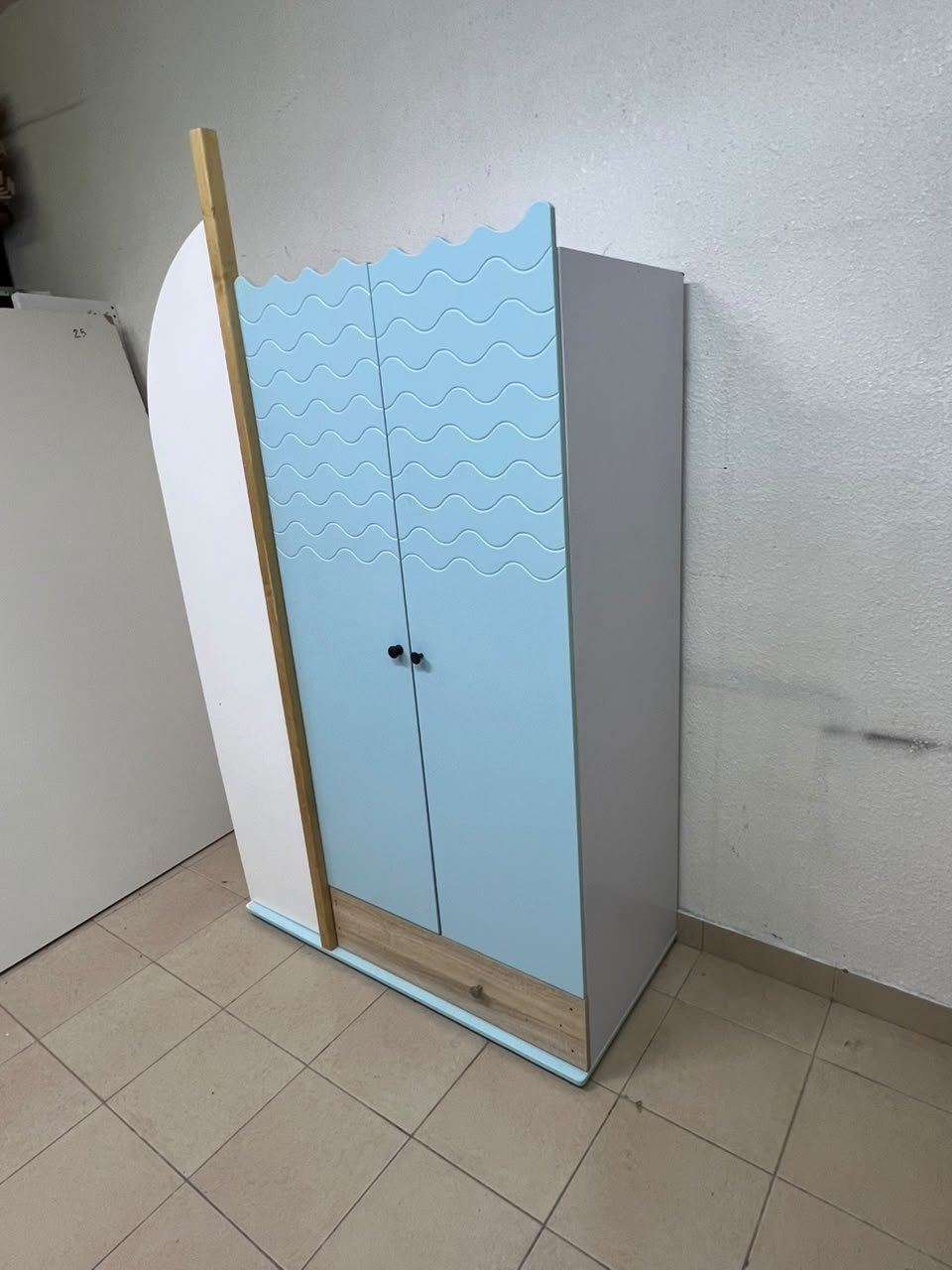 The photo shows a children's wardrobe with a distinctive nautical design in blue and white with wooden details and wave-like top edges. - Image 7