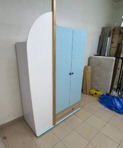 The photo shows a children's wardrobe with a distinctive nautical design in blue and white with wooden details and wave-like top edges. - Image 3