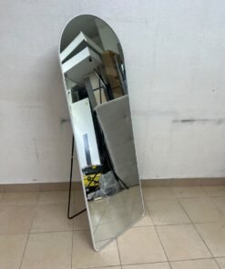 A full-length floor mirror featuring an arched design with a curved top, a white frame, and a black metal back stand; it resembles the Noon East arched mirrors available on Noon or similar freestanding mirror designs found on Amazon UAE.