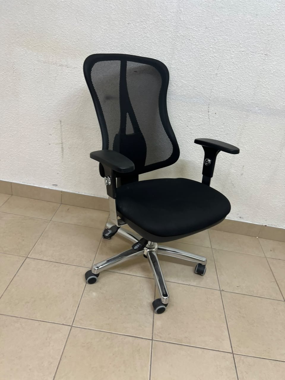 The Topstar Head Point is a comfortable office chair featuring a breathable black mesh back with built-in lumbar support and a shiny silver metal base. - Image 6