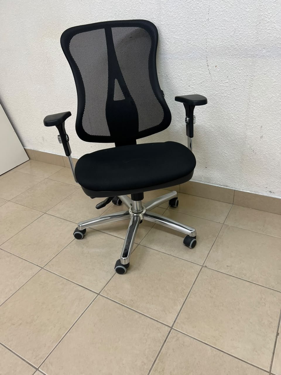The Topstar Head Point is a comfortable office chair featuring a breathable black mesh back with built-in lumbar support and a shiny silver metal base. - Image 7